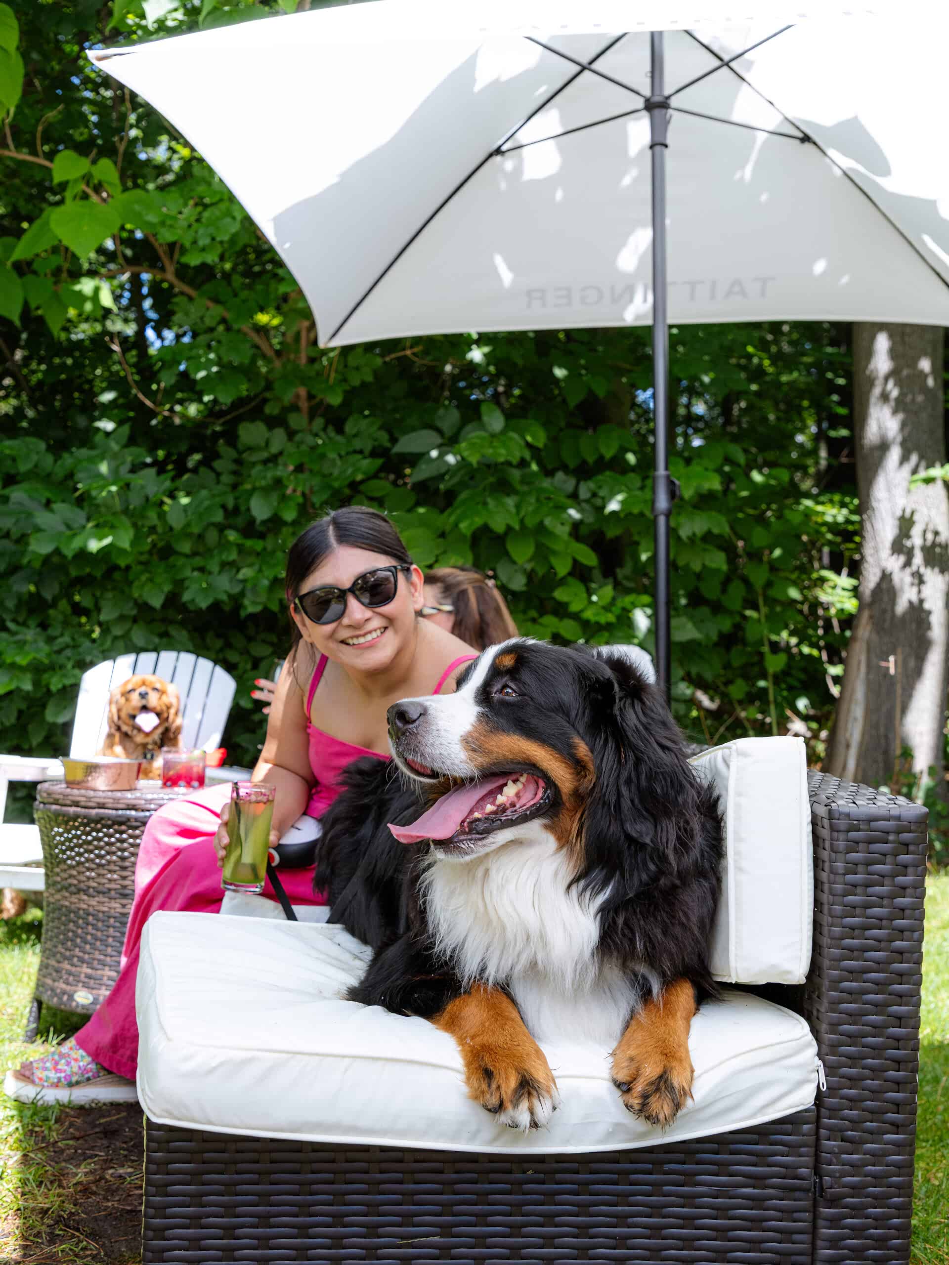 woman with dog and a cocktail in a garden for yappy hour